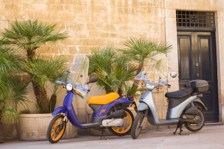 BARI, ITALY - JULY 11,2018, Typical street scene in Bari with a two old scooter on an old narrow cobblestoned street, Apulia, Italyのeditorial素材