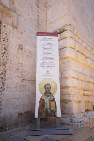 BARI, ITALY - JULY 11, 2018, - Sign welcome in several languages, Basilica of San Nicola in Bari, Apulia. Basilica of St. Nicholas, in the crypt where the relics of St. Nicholas from 1087 in Bariのeditorial素材