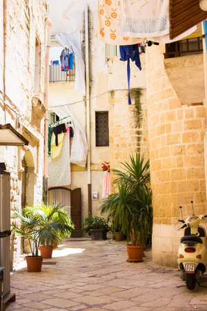 BARI, ITALY - JULY 11, 2018, View of a narrow street in the Italian city Bari, linen is dried in the streetのeditorial素材