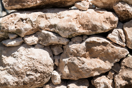 natural stone background - close up of muretto a secco - old traditional Apulian architectural art, Salento, regione of Puglia, Italyのeditorial素材
