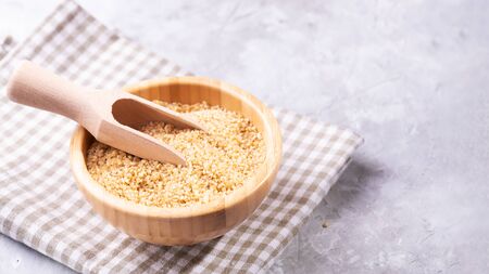 Uncooked raw dry bulgur wheat grains in a bowlの写真素材