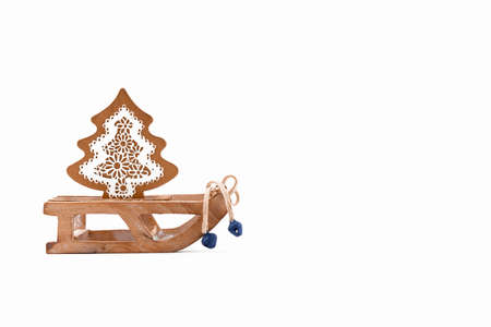 A wooden zero waste small toy sleigh with wooden Christmas tree, New year is coming. Reusable...