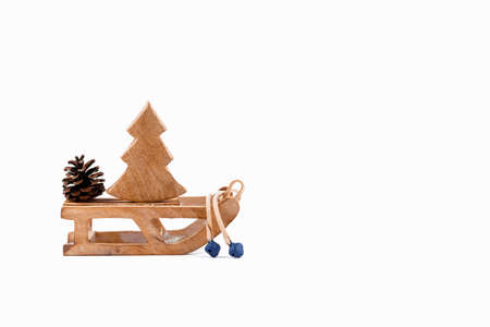 A wooden zero waste small toy sleigh with wooden Christmas tree, New year is coming. Reusable...