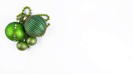 Christmas green balls and festive decoration on a white background top view, New year bannerの写真素材
