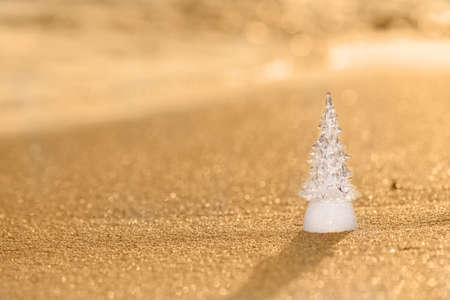 Timber wooden Christmas tree on a sand on the tropical beach near ocean, summer Christmas and winter holyday conceptの写真素材
