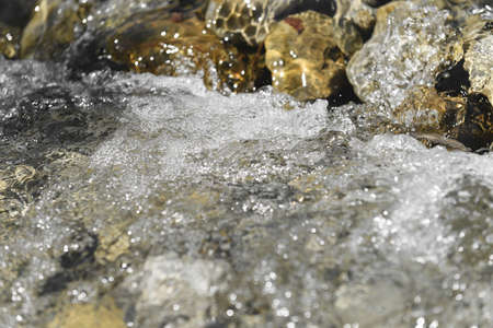 Crystal clean mountain stream flowing in nature. Rocky stream. Water flowing downwards over cliffs...