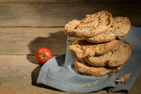 Italian appetizer Friselle. Apulian dried bread Friselle in wooden backgroundの写真素材