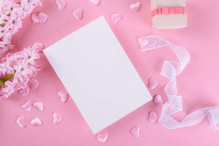 Invitation or greeting card mockup with envelope and hyacinth flowers on dark wooden background