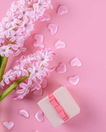 Gift or present box and stars confetti on pink table top view. Flat lay composition for birthday, mother day or wedding.の写真素材
