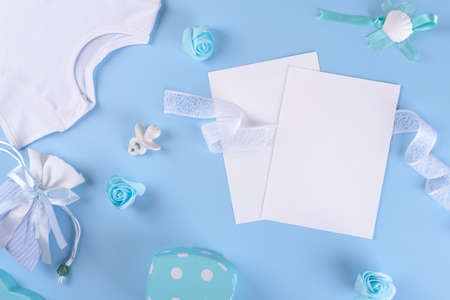 Baby shower invitation 5x7 two card mockup with baby boy accessories, bodysuit, nipple or baby's...