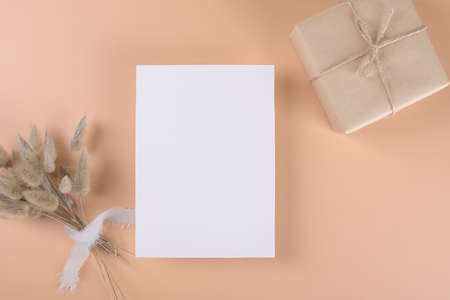 Wedding stationery invitation card mockup 5x7 on neutral beige background with boho decorationの写真素材