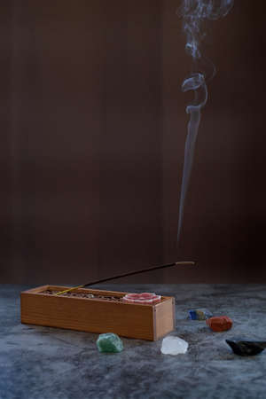 Burning aromatic incense smoke stick for meditation and relaxing with natural magic crystals. Aromatherapy smoke for yoga conceptの写真素材