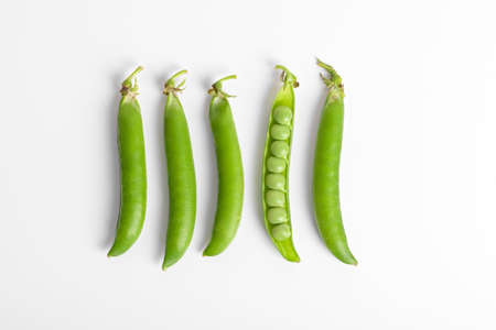 Fresh organic raw green peas pods on white background. Healthy eating, bean proteinの写真素材