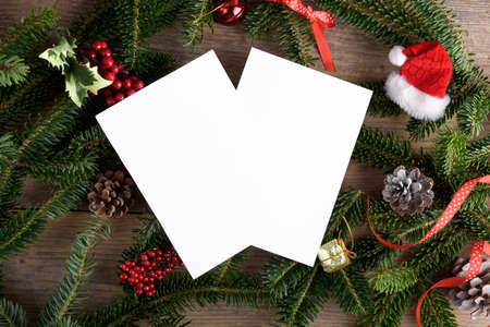 Two Christmas 5x7 card mockup template with fir twigs and Christmas decoration on wooden background....