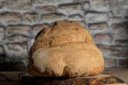 The bread of Matera, Pane di Matera on rustic wooden background, typical southen italian sourdough bread, close upの写真素材