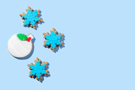 Christmas cookies shape of ball and snowflakes form on the blue background, top view, flat lay, copy space.の写真素材
