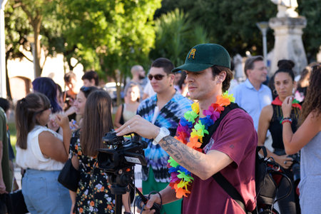 Manduria, Italy - JULY, 13, 2022. A cameraman during a gay pride is filming LGBT marches in the...