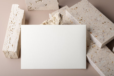 Wedding stationery invitation card mockup 7x5 on beige background and pieces of travertne marble stone. bridal shower mockup. Minimal boho style blank mockup, thank you card, greeting cardの写真素材
