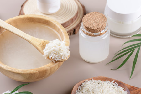 Homemade cosmetic rice water with ingredients and beauty kit on beige background, healthy beauty treatment ingredients for homemade comsetics, beauty recipe for home spa, natural skincare preparationの写真素材