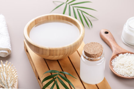 Homemade cosmetic rice water with ingredients and beauty kit on beige background, healthy beauty treatment ingredients for homemade comsetics, beauty recipe for home spa, natural skincare preparationの写真素材