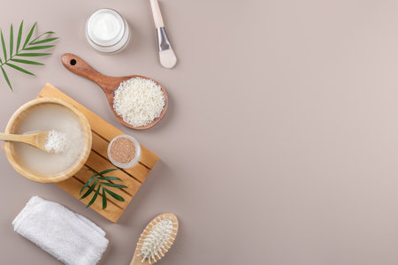 Homemade cosmetic rice water with ingredients on beige background, healthy beauty treatment ingredients for homemade comsetics, beauty recipe for home spa, natural skincare preparation, top viewの写真素材