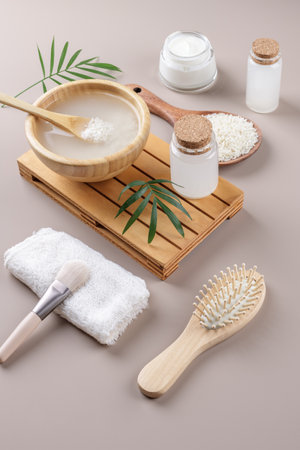 Homemade cosmetic rice water with ingredients and beauty kit on beige background, healthy beauty treatment ingredients for homemade comsetics, beauty recipe for home spa, natural skincare preparationの写真素材