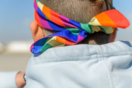 Person head from behind with headband in colors of rainbow LGBTの写真素材
