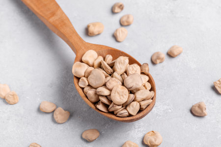 Organic dry Grass pea close up on wooden spoon