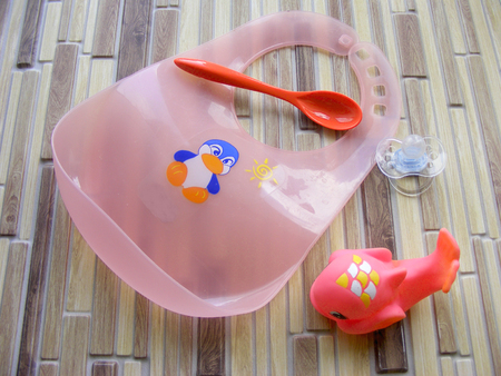 baby spoon, kitchen and toys closeup