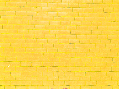 Old yellow brick wall background for spring or summer card or easter backgroundの写真素材