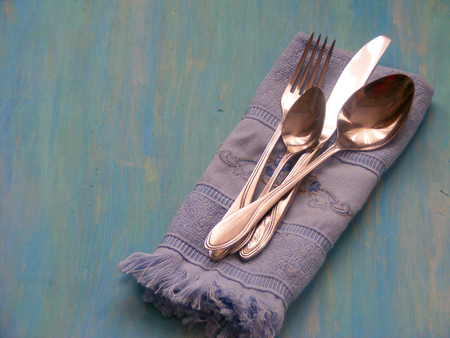 vintage knife, spoon and fork on blue wooden backgroundの写真素材