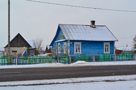 Belarus. Russian village on snowy background. Rustic wooden wall texture. Country architecture.の写真素材