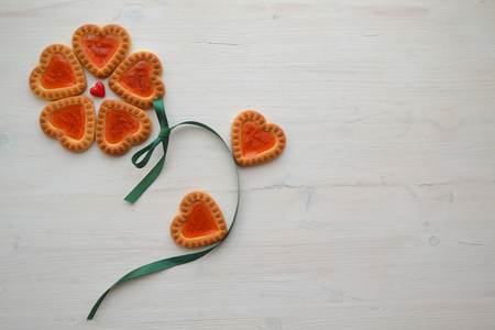 Closeup of biscuit for celebration design. Heart love symbol card with copyspace. Relationship concept with cookie in form of flowerの写真素材