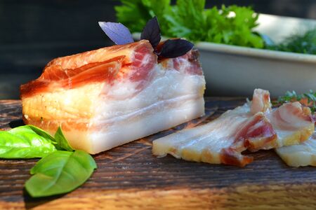 Salted Lard, Raw Pork with Spices on dark Wooden background.の写真素材