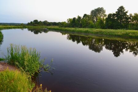 River landscape on a summer evening in Belarus, river Schara at Slonim village. Summer nature river...