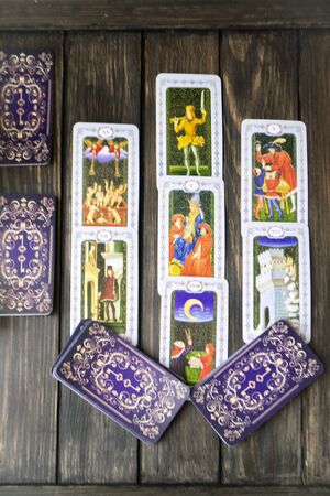 tarot cards divination witchcraft, black wooden background, vertical imageの写真素材