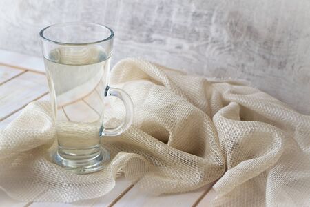 Cold fresh birch juice in a glass on a wooden tableの写真素材
