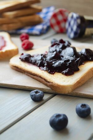 sweet blueberries jam on toast close up, vertical imageの写真素材