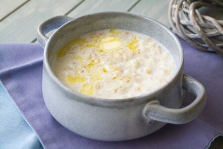 Milk soup with dough on wooden tableの写真素材