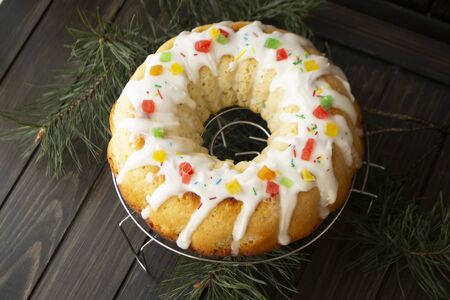Traditional yeast cake covered with white icing and raisins Spongy yeast cake that is traditionally...