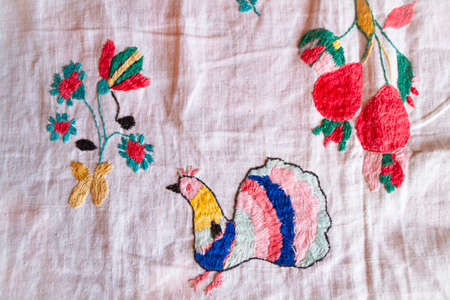 peacock hand made embroidered smooth decoration on white fabric, vintage folk embroidery in Belarus, second half of 19 centuryの写真素材