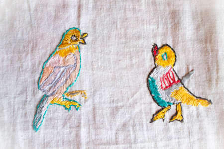 nightingale hand made embroidered smooth decoration on white fabric, vintage folk embroidery in...