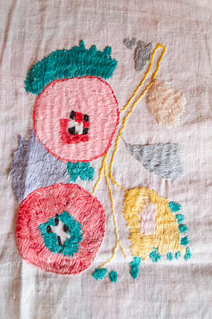 peach handmade embroidered smooth decoration on white fabric , vintage folk embroidery in Belarus,...