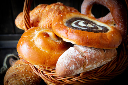 Mixed fresh bread and buns. Rustic loaves of bread close up.