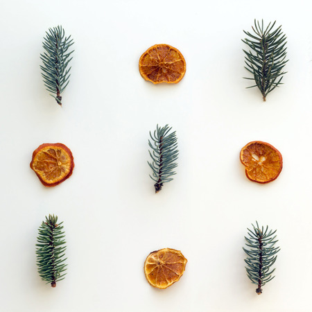 Christmas concept. Composition with dried orange and mandarin and fir branches on white background. Flat lay, top viewの写真素材