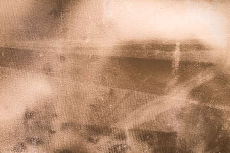 Old gold paper. Golden texture Uneven background with the effect of distressed, scratches, bumps, creases, folds and fadin, attrition, abrasionの写真素材