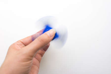 Hand Spiner. Stress relieving toy on white background. Close-up. Top view. Stock photo.の写真素材
