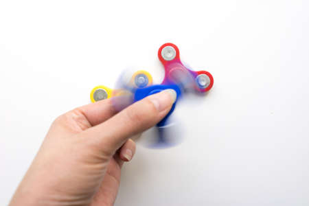 Hand Spiner. Stress relieving toy on white background. Close-up. Top view. Stock photo.の写真素材