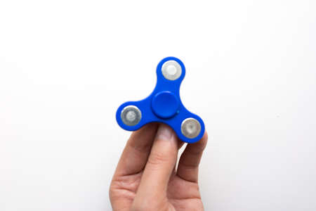 Hand Spiner. Stress relieving toy on white background. Close-up. Top view. Stock photo.の写真素材