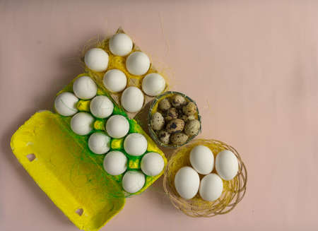 White chicken Chicken and quail eggs in colored paper eco-friendly packaging with decorative sisal.の写真素材